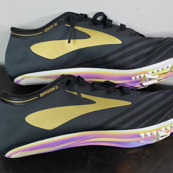 black and gold track shoes
